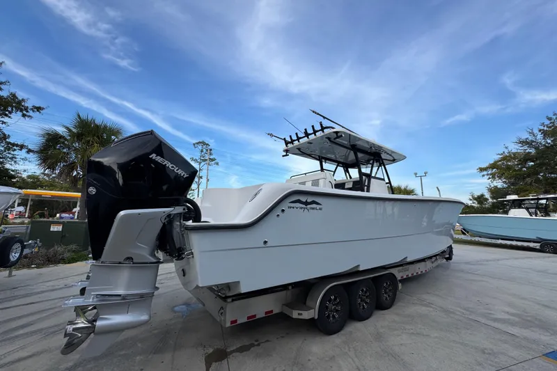  Yacht Photos Pics 2021 Invincible 35' Catamaran with Mercury engine on trailer, parked outdoors.