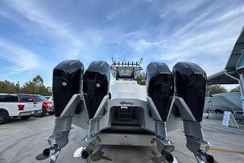  Yacht Photos Pics 2021 Invincible 35' Catamaran with four powerful outboard engines, parked outdoors.