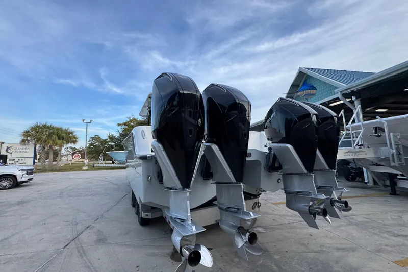  Yacht Photos Pics 2021 Invincible 35' Catamaran with triple outboard engines at a marina.