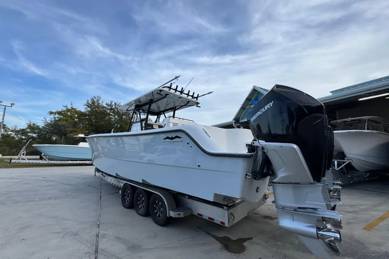  Yacht Photos Pics 2021 Invincible 35' Catamaran with Mercury engines on a trailer, parked outdoors.
