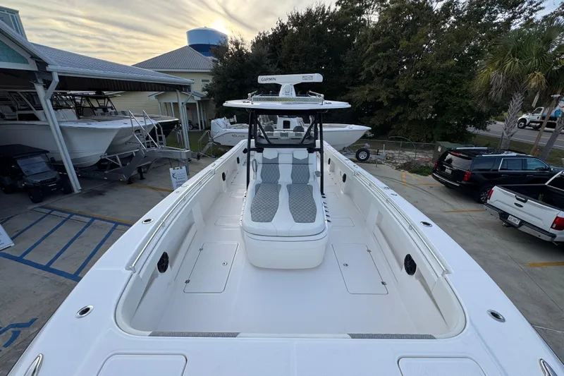  Yacht Photos Pics 2021 Invincible 35' Catamaran docked, showcasing spacious deck and modern design.