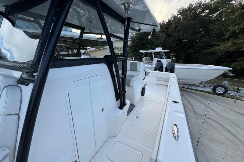  Yacht Photos Pics 2021 Invincible 35' Catamaran, sleek design, docked with another boat in the background.