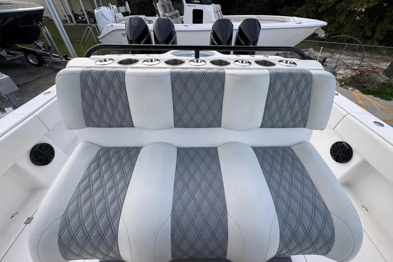  Yacht Photos Pics Luxurious seating on 2021 Invincible 35' Catamaran with diamond-stitched upholstery and cup holders.