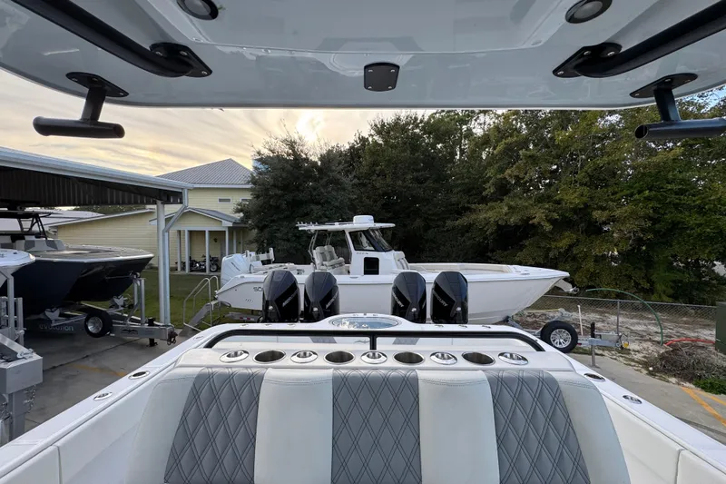  Yacht Photos Pics 2021 Invincible 35' Catamaran with dual Mercury engines, docked near other boats.