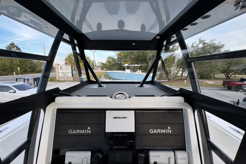  Yacht Photos Pics 2021 Invincible 35' Catamaran cockpit with Garmin and Mercury controls, outdoor view.