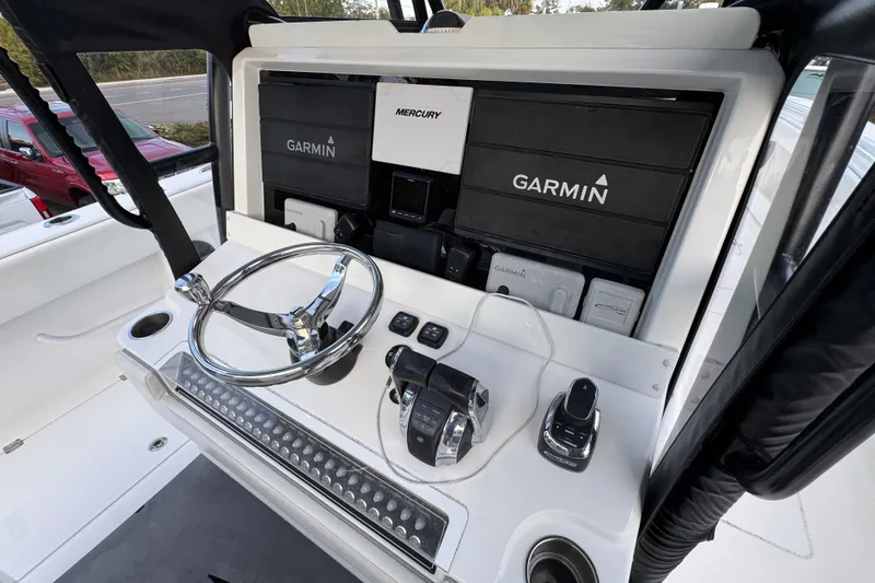  Yacht Photos Pics 2021 Invincible 35' Catamaran helm with Garmin navigation and Mercury controls.