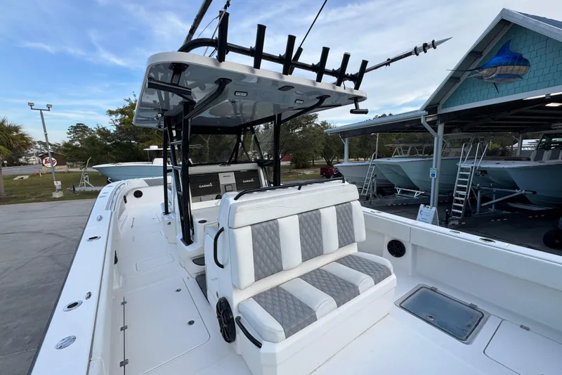  Yacht Photos Pics 2021 Invincible 35' Catamaran with seating and rod holders, docked at a marina.