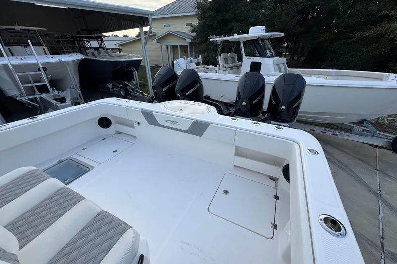  Yacht Photos Pics 2021 Invincible 35' Catamaran with multiple outboard engines in a boatyard setting.