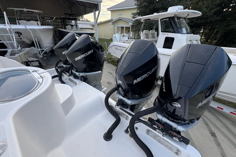  Yacht Photos Pics 2021 Invincible 35' Catamaran with four Mercury outboard engines, docked in a marina.