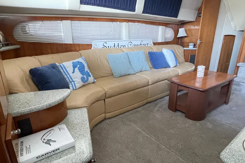 Sudden Comfort Yacht Photos Pics Interior of 2001 Carver 444 Cockpit Motor Yacht with beige sofa and blue cushions.