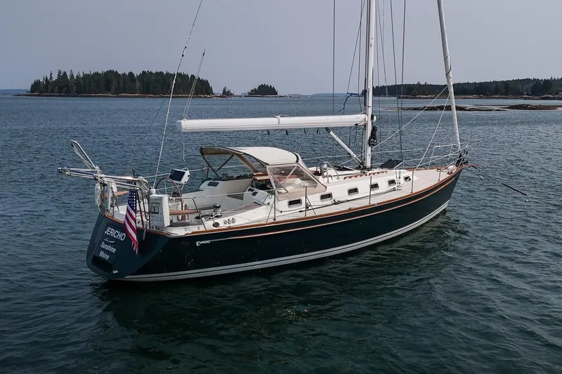 Jericho Yacht Photos Pics Sailboat Tartan 4100, 2002 model, anchored in calm waters with scenic island backdrop.