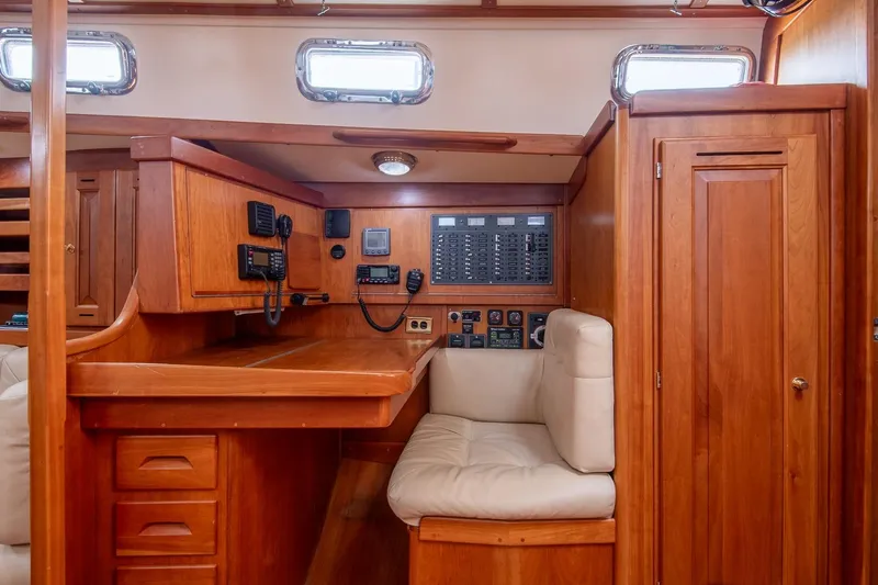 Jericho Yacht Photos Pics Interior of 2002 Tartan 4100 sailboat with navigation station and wooden cabinetry.