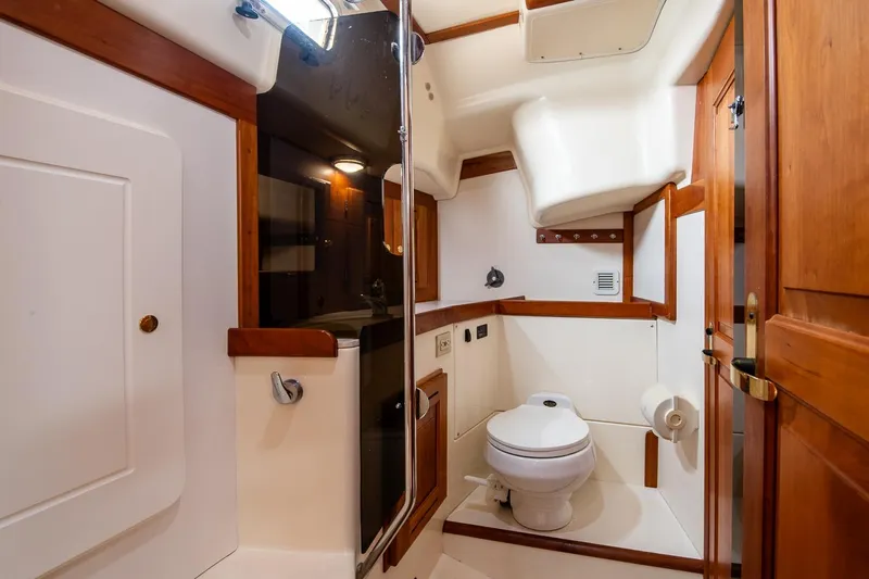 Jericho Yacht Photos Pics Luxurious 2002 Tartan 4100 yacht bathroom with wooden accents and modern amenities.