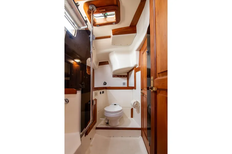 Jericho Yacht Photos Pics Luxurious 2002 Tartan 4100 yacht bathroom with wooden accents and modern fixtures.