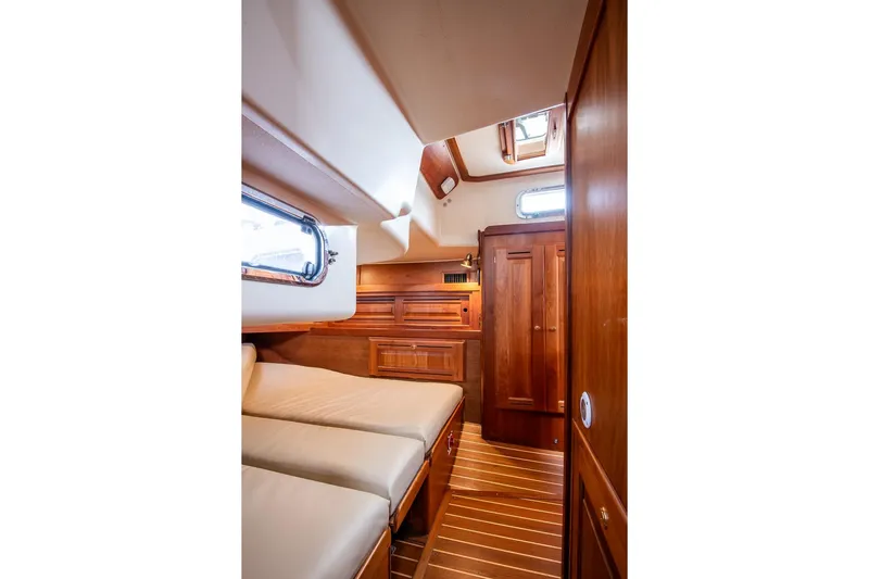 Jericho Yacht Photos Pics Luxurious cabin interior of 2002 Tartan 4100 yacht with wooden finishes and cozy bedding.