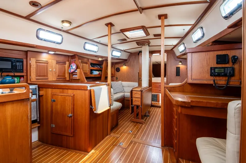 Jericho Yacht Photos Pics Interior of a 2002 Tartan 4100 sailboat with wooden cabinetry and seating.