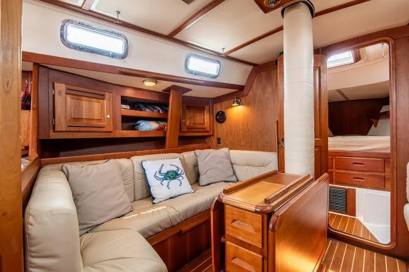 Jericho Yacht Photos Pics Luxurious 2002 Tartan 4100 yacht interior with cozy seating and elegant wood finish.