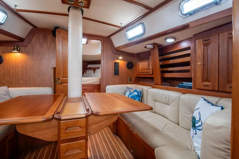 Jericho Yacht Photos Pics Luxurious 2002 Tartan 4100 yacht interior with wood finish and plush seating.