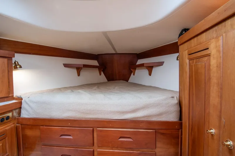 Jericho Yacht Photos Pics Cozy cabin interior of 2002 Tartan 4100 sailboat with wooden furnishings and bed.