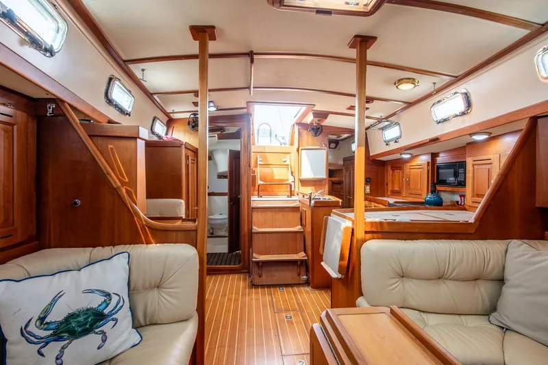 Jericho Yacht Photos Pics Luxurious 2002 Tartan 4100 yacht interior with wood finish and comfortable seating.