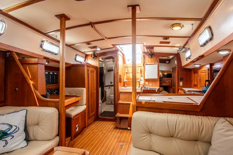 Jericho Yacht Photos Pics Luxurious interior of 2002 Tartan 4100 sailboat with wood finish and comfortable seating.