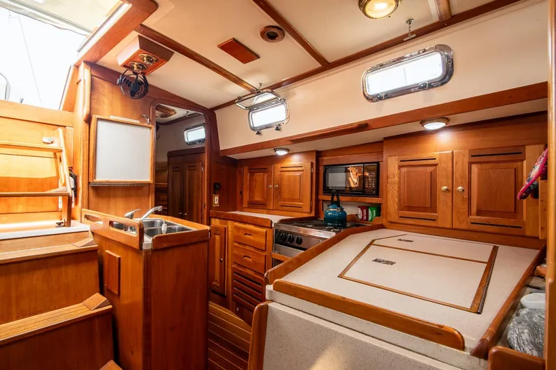 Jericho Yacht Photos Pics Interior of 2002 Tartan 4100 sailboat with wooden cabinetry and modern amenities.