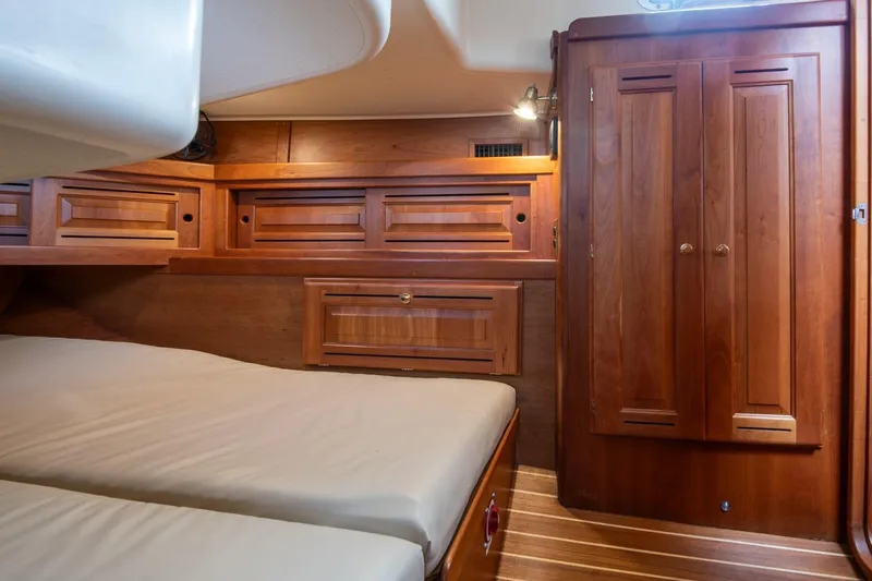 Jericho Yacht Photos Pics Luxurious wooden cabin interior of 2002 Tartan 4100 yacht with cozy bedding.