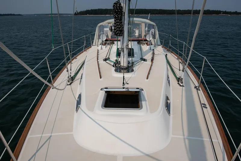 Jericho Yacht Photos Pics Sailing yacht Tartan 4100, 2002 model, on calm waters with visible deck and rigging.