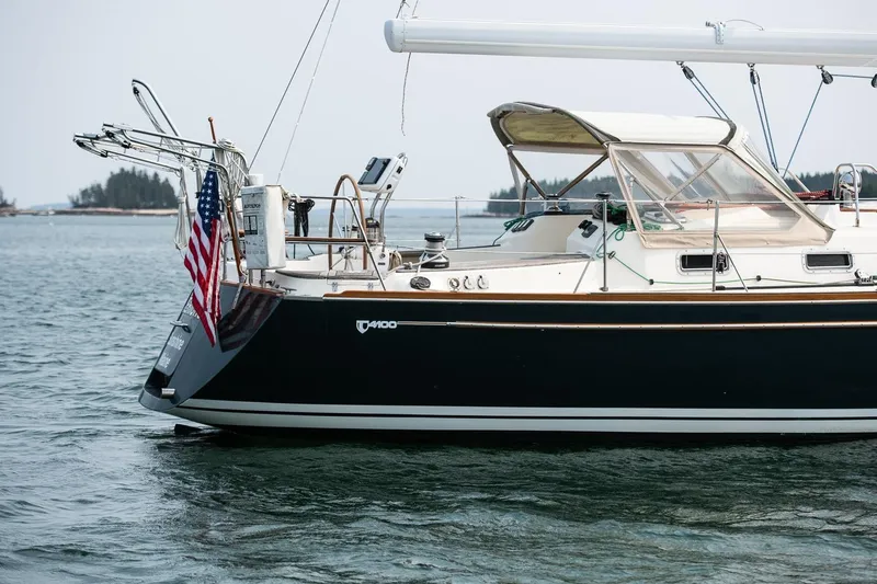 Jericho Yacht Photos Pics Sailboat Tartan 4100, 2002 model, anchored with American flag, calm waters.