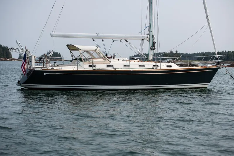 Jericho Yacht Photos Pics Sailboat Tartan 4100, 2002 model, anchored in calm waters with scenic background.