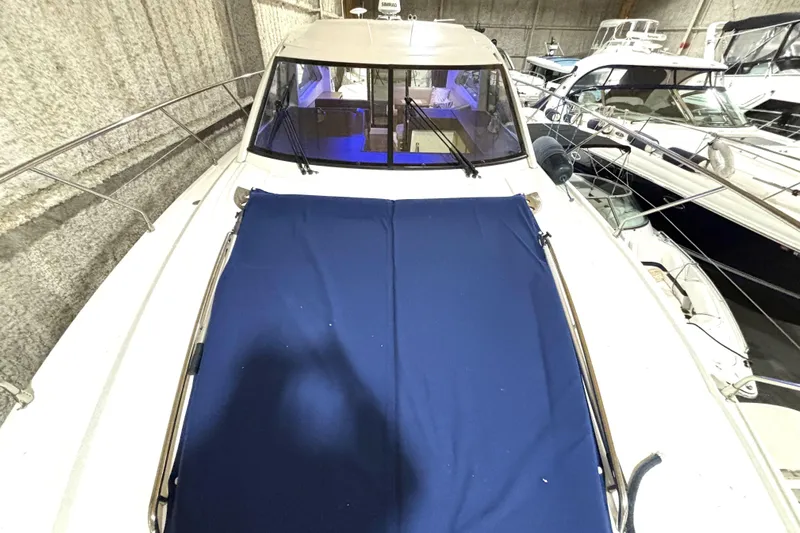  Yacht Photos Pics 2015 Beneteau Gran Turismo 49 yacht with blue cover, docked indoors.