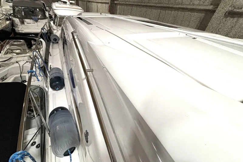  Yacht Photos Pics 2015 Beneteau Gran Turismo 49 yacht docked in a marina, side view.