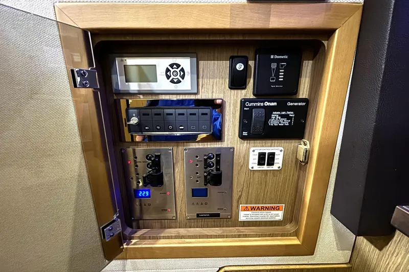  Yacht Photos Pics Control panel of a 2015 Beneteau Gran Turismo 49 yacht, featuring various switches and displays.