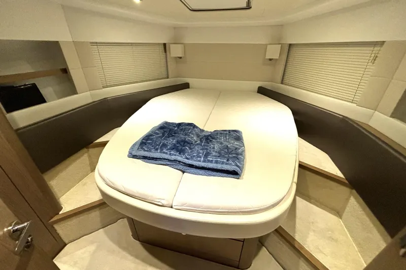  Yacht Photos Pics Luxurious cabin interior of 2015 Beneteau Gran Turismo 49 yacht with plush bedding.