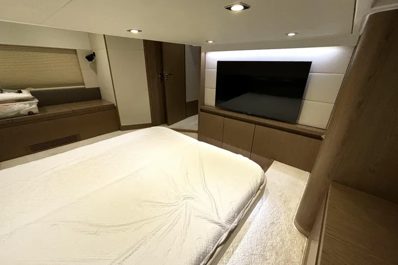  Yacht Photos Pics Luxurious interior of 2015 Beneteau Gran Turismo 49 yacht with modern bedroom and TV.