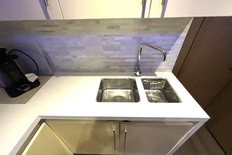  Yacht Photos Pics Modern kitchen sink area on 2015 Beneteau Gran Turismo 49 yacht, featuring dual sinks and sleek faucet.