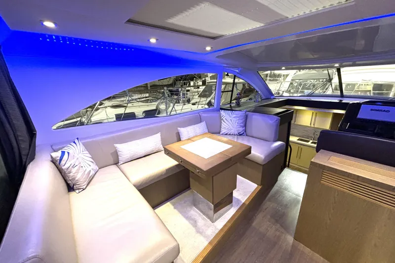  Yacht Photos Pics Luxurious interior of 2015 Beneteau Gran Turismo 49 yacht with modern seating and ambient lighting.