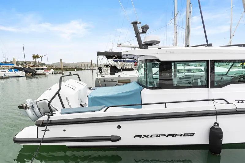 Egret Yacht Photos Pics 2023 Axopar 37 boat docked in marina, featuring sleek design and modern outboard engine.