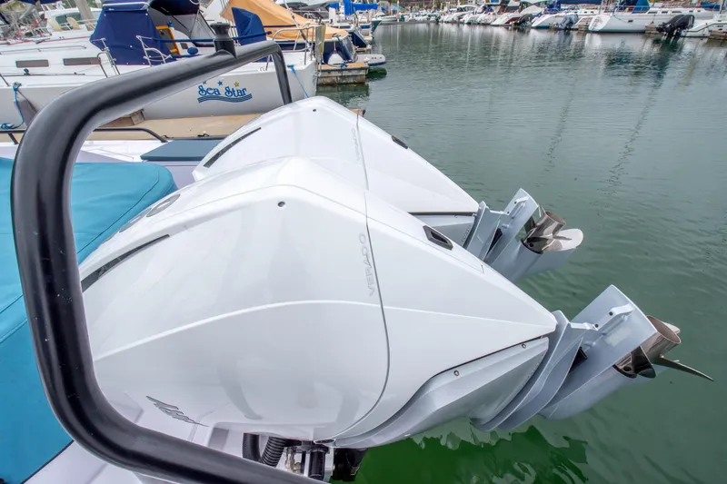Egret Yacht Photos Pics 2023 Axopar 37 boat with dual outboard engines docked in a marina.