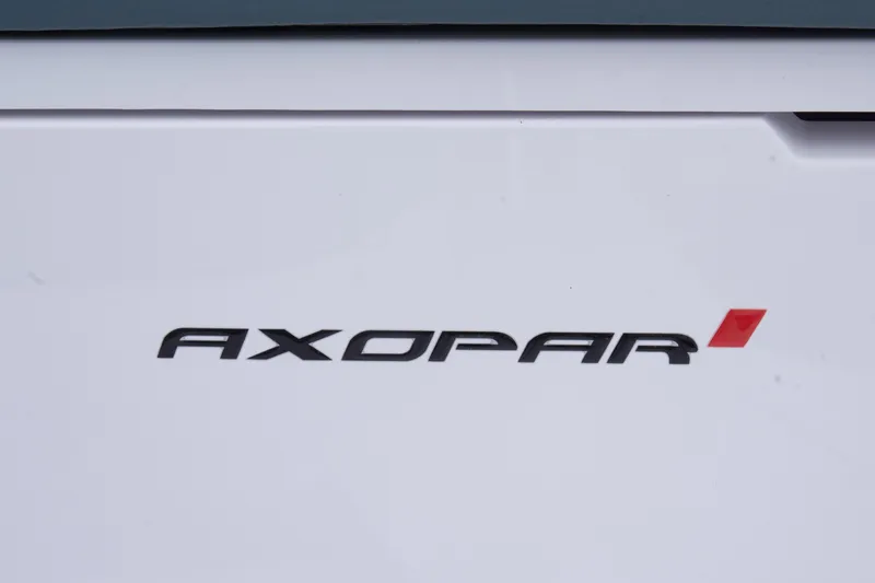 Egret Yacht Photos Pics Axopar 37 logo on a 2023 model boat, featuring sleek black and red design.
