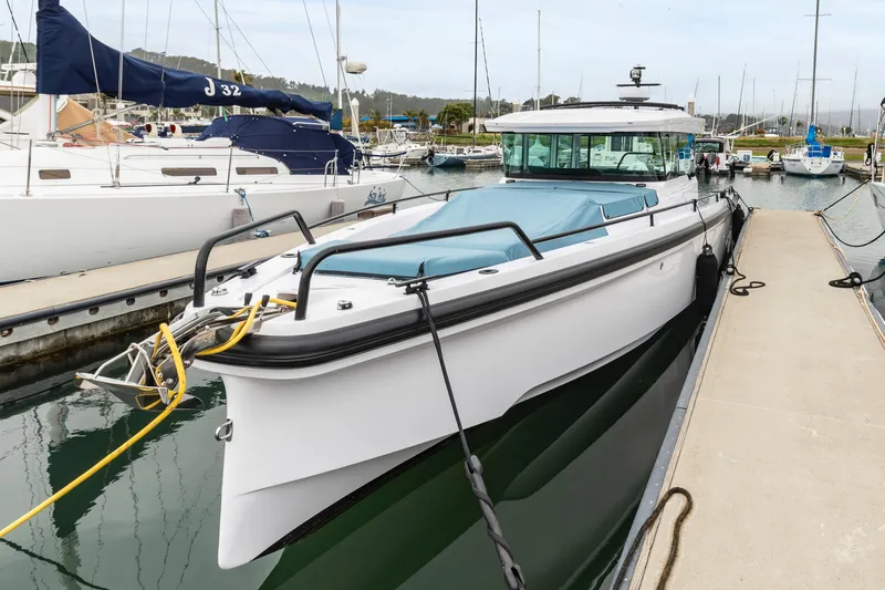 Egret Yacht Photos Pics 2023 Axopar 37 boat docked in marina, featuring sleek design and modern amenities.