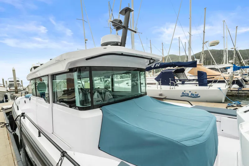 Egret Yacht Photos Pics 2023 Axopar 37 boat docked in marina, featuring sleek design and blue cover.