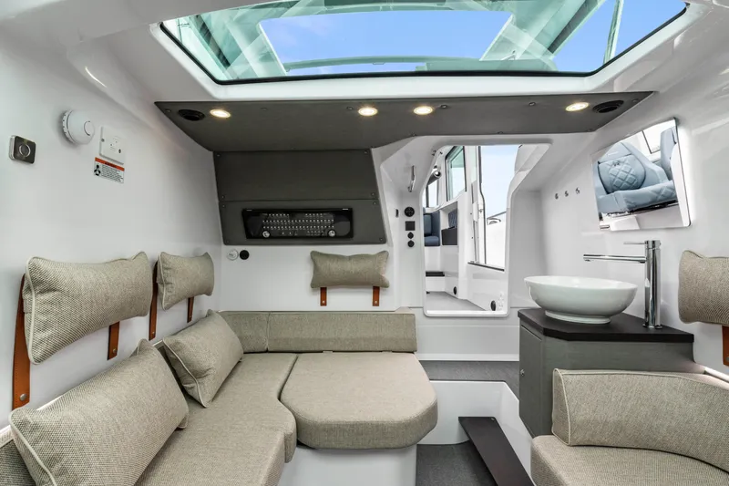 Egret Yacht Photos Pics Luxurious interior of 2023 Axopar 37 boat with modern seating and skylight.