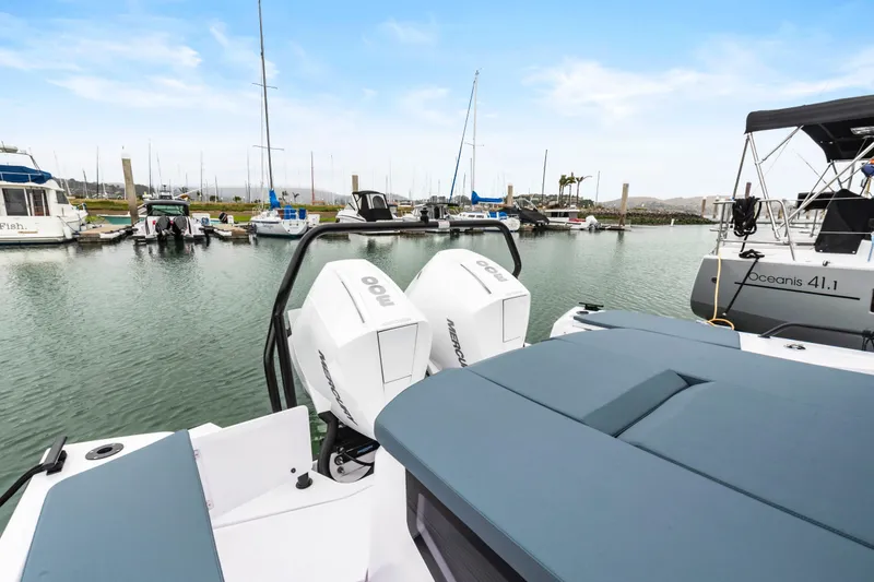 Egret Yacht Photos Pics 2023 Axopar 37 boat with twin outboard engines docked in a marina.