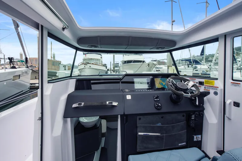 Egret Yacht Photos Pics Interior view of 2023 Axopar 37 boat cockpit with modern navigation equipment.