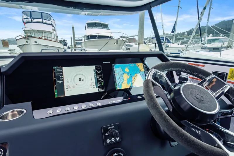 Egret Yacht Photos Pics Helm of 2023 Axopar 37 boat with navigation screens and steering wheel.