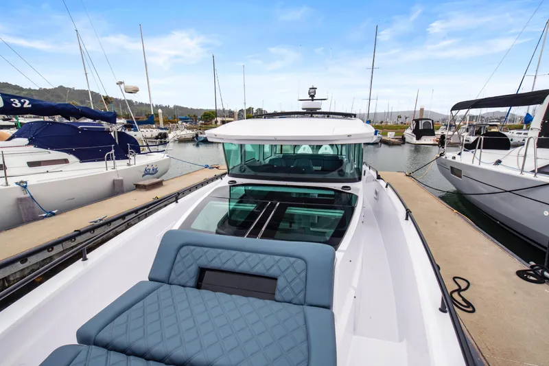 Egret Yacht Photos Pics 2023 Axopar 37 boat docked at marina, featuring sleek design and comfortable seating.