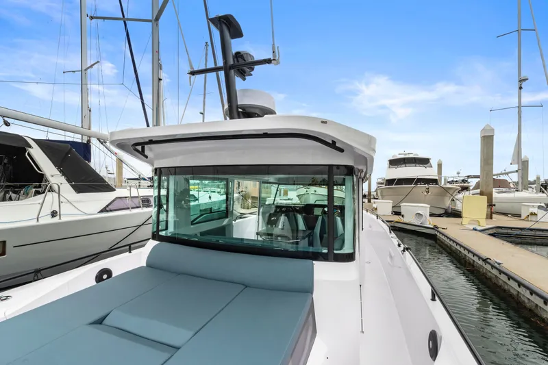 Egret Yacht Photos Pics 2023 Axopar 37 boat docked at marina, featuring sleek design and spacious deck.