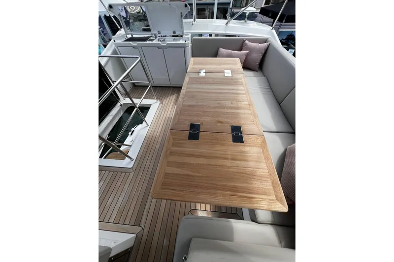 Sealine F430 Yacht Photos Pics Luxurious 2020 Sealine F430 yacht interior with wooden table and cushioned seating.