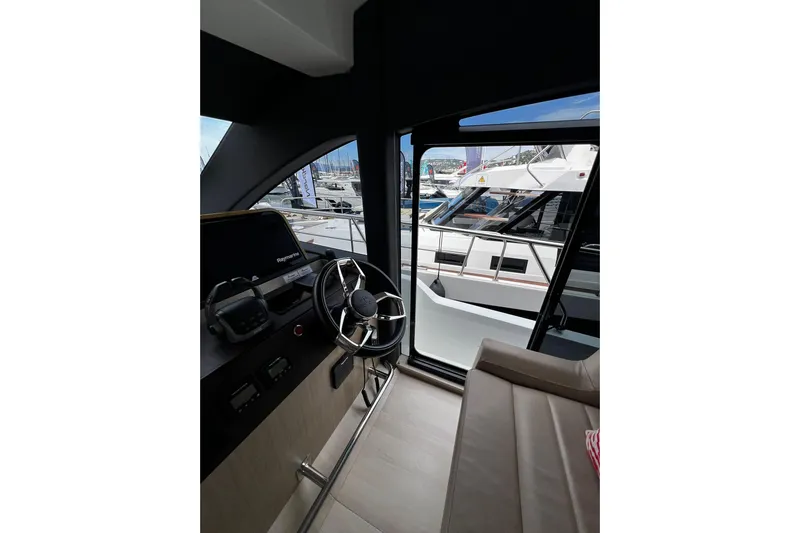 Sealine F430 Yacht Photos Pics Interior view of 2020 Sealine F430 yacht cockpit with steering wheel and controls.